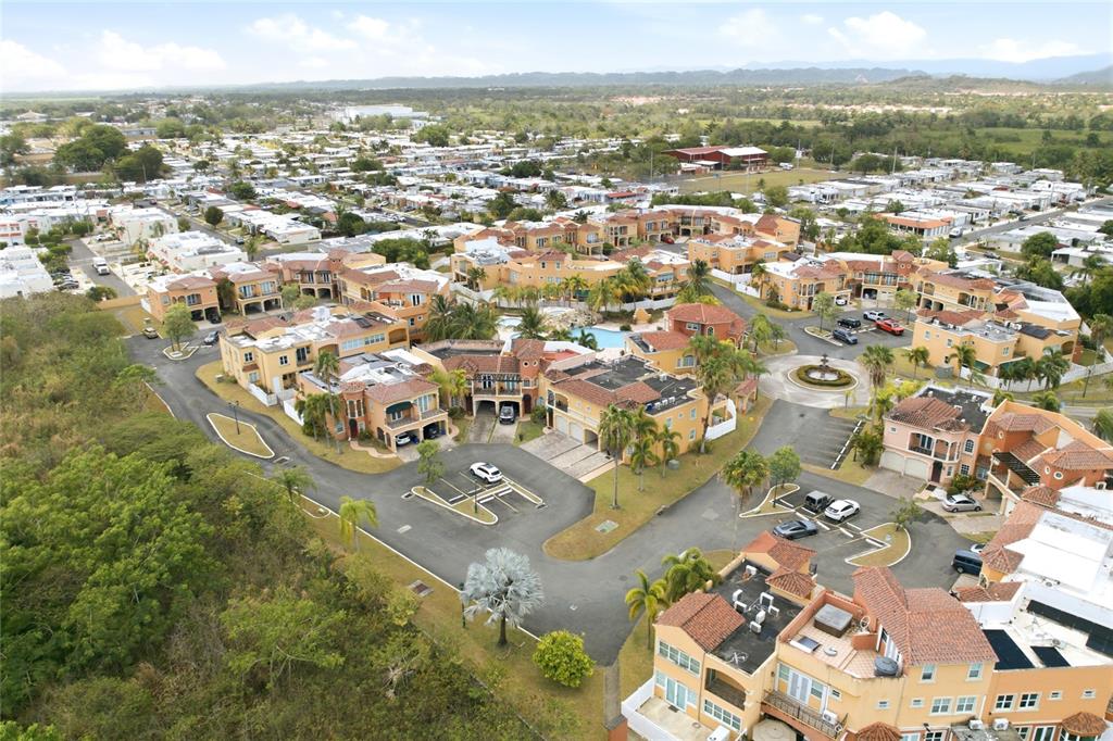 An aerial view shows a residential complex with multi-story buildings, parking areas, and a pool — E-2 BRIGHTON COUNTRY CLUB, DORADO, PR