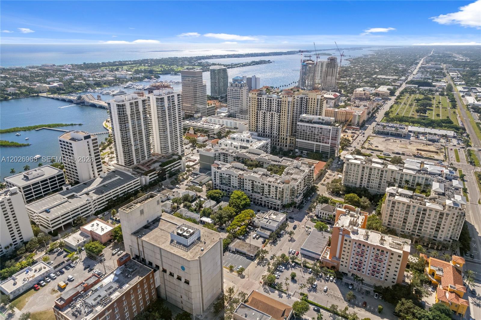 An aerial view shows a dense urban cityscape with high-rise buildings near a waterfront — 515 S Dixie Hwy, West Palm Beach FL 33401, WEST PALM BEACH, FL