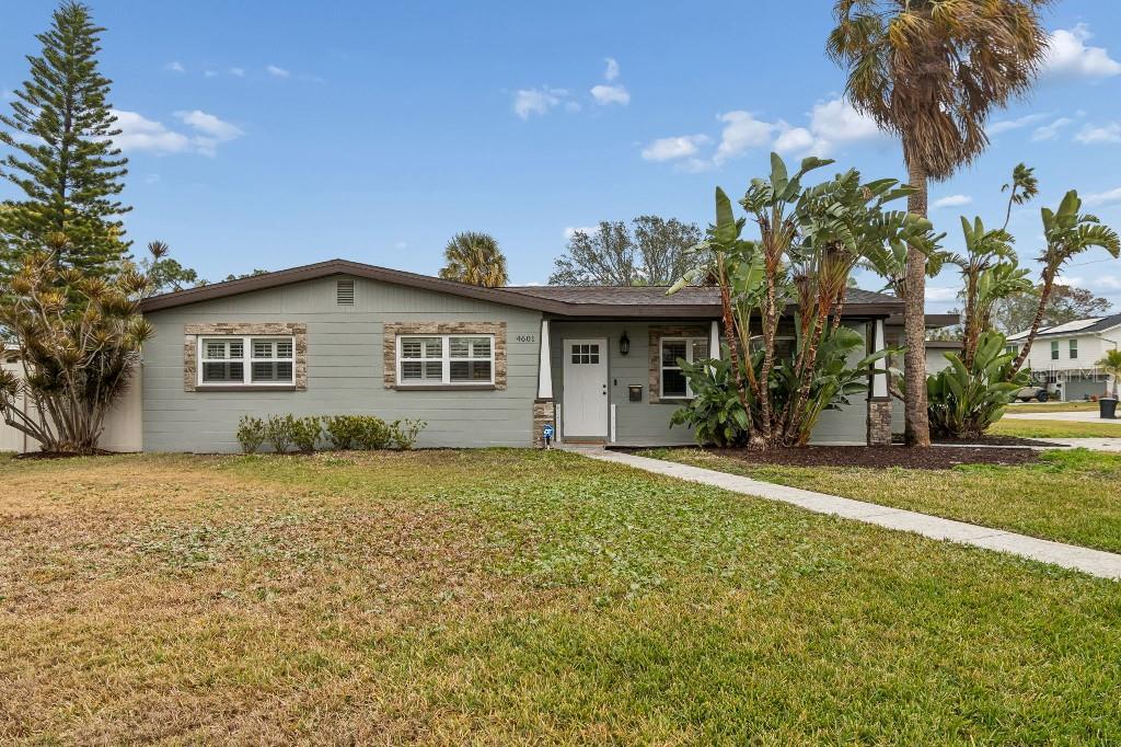 A single-story house with light green siding, stone accents, and a front walkway — 4601 VENETIAN BOULEVARD NE, ST PETERSBURG, FL