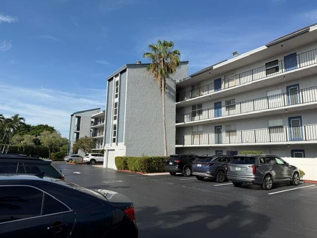 A multi-story apartment building with balconies and a parking lot in the foreground — 6675 S Oriole Boulevard # 4040, Delray Beach FL 33446, DELRAY BEACH, FL