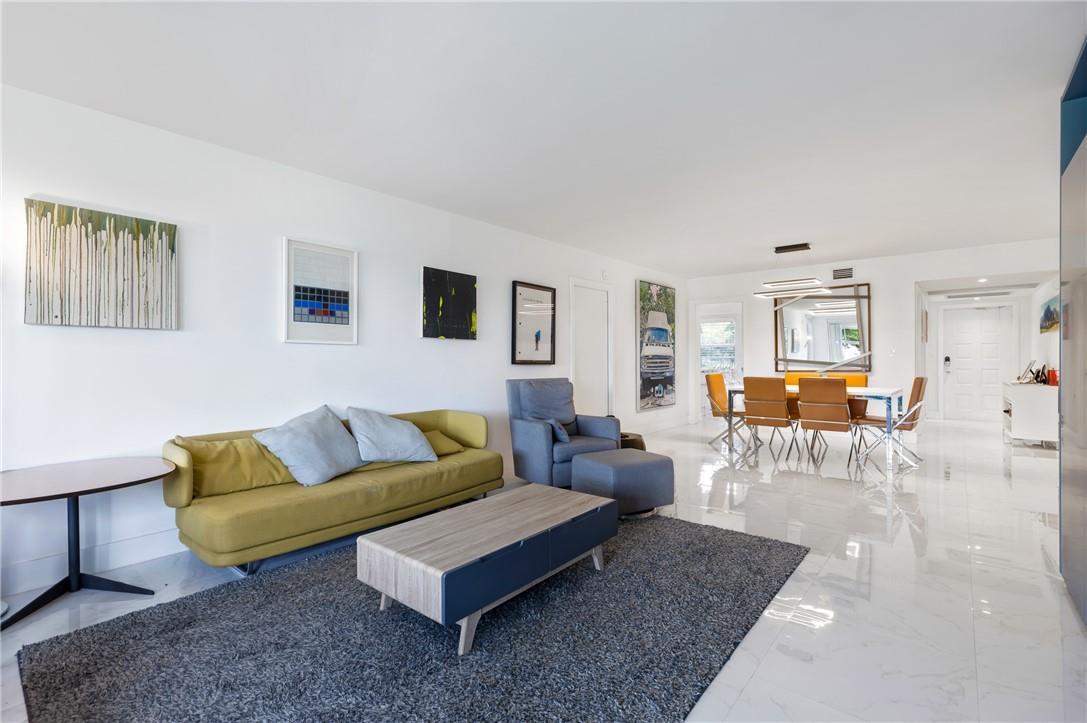 A living and dining area with white walls, marble floors, and modern furniture — 805 Cypress Boulevard # 210, Pompano Beach FL 33069, POMPANO BEACH, FL