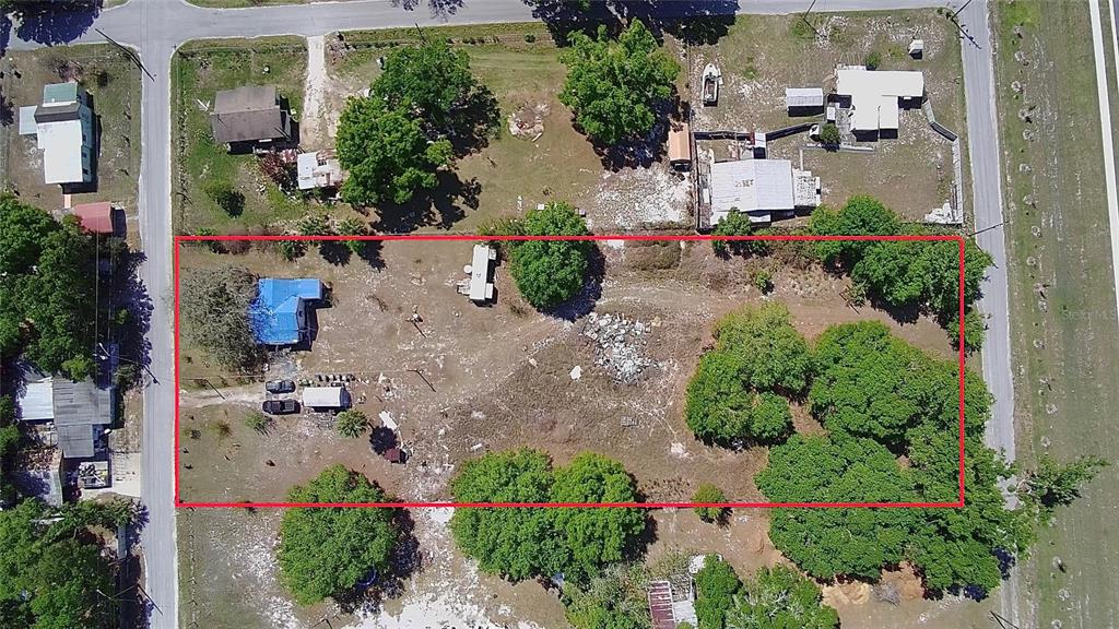 An aerial view shows a rectangular lot with a house, outbuildings, and scattered trees — 1701 SANFORD STREET, LAKE WALES, FL