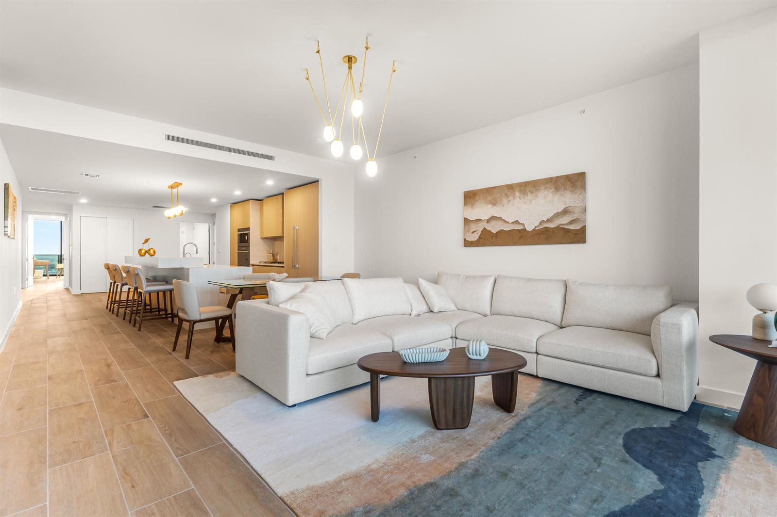 A modern living room features a white sectional sofa, a coffee table, and an area rug — 900 N Ocean Boulevard # 1904, Pompano Beach FL 33062, POMPANO BEACH, FL