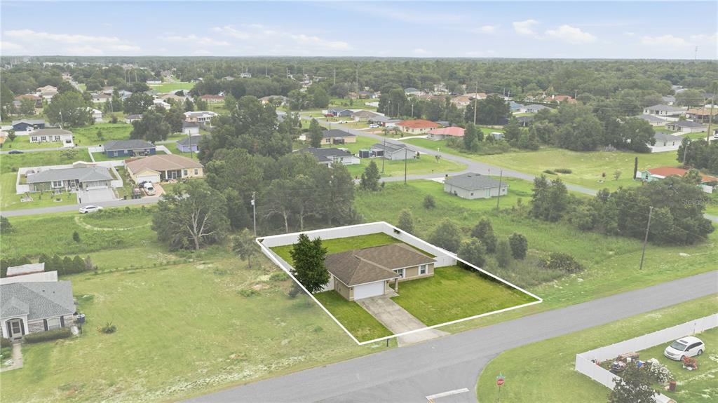An aerial view shows a single-story house with a fenced yard on a suburban lot — 4801 145TH PLACE, OCALA, FL
