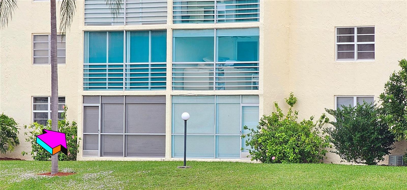 Exterior view of a multi-story apartment building with screened-in balconies and landscaped grounds — 121 SE 3rd Avenue # 106, Dania Beach FL 33004, DANIA BEACH, FL