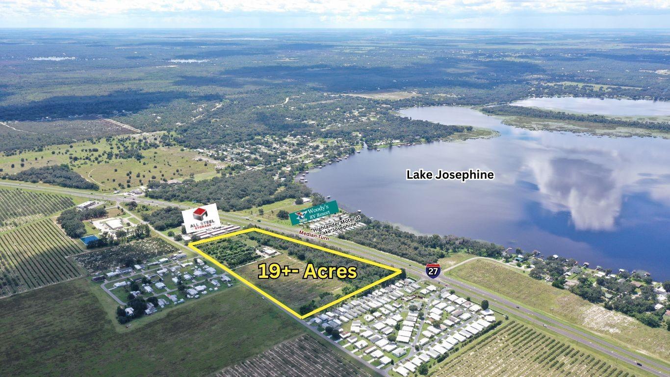 An aerial view shows a 19-acre plot of land bordering Highway 27 near Lake Josephine — 11400 Us-27, Sebring FL 33876, SEBRING, FL