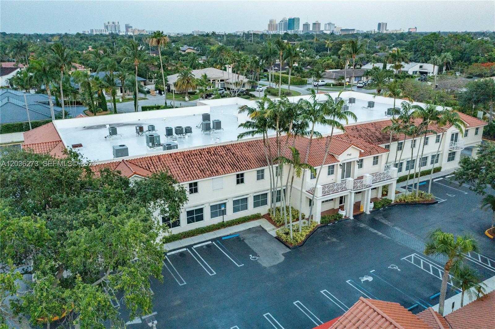 An aerial view shows a two-story commercial building with a white facade and tiled roof — 7765 SW 87th Ave # 212A, Miami FL 33173, MIAMI, FL