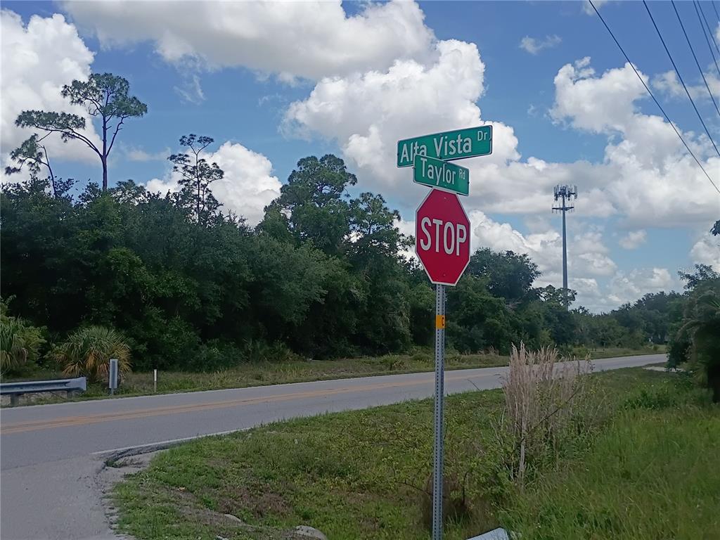 A stop sign stands at the intersection of Alta Vista Drive and Taylor Road — 6255 TAYLOR ROAD, PUNTA GORDA, FL