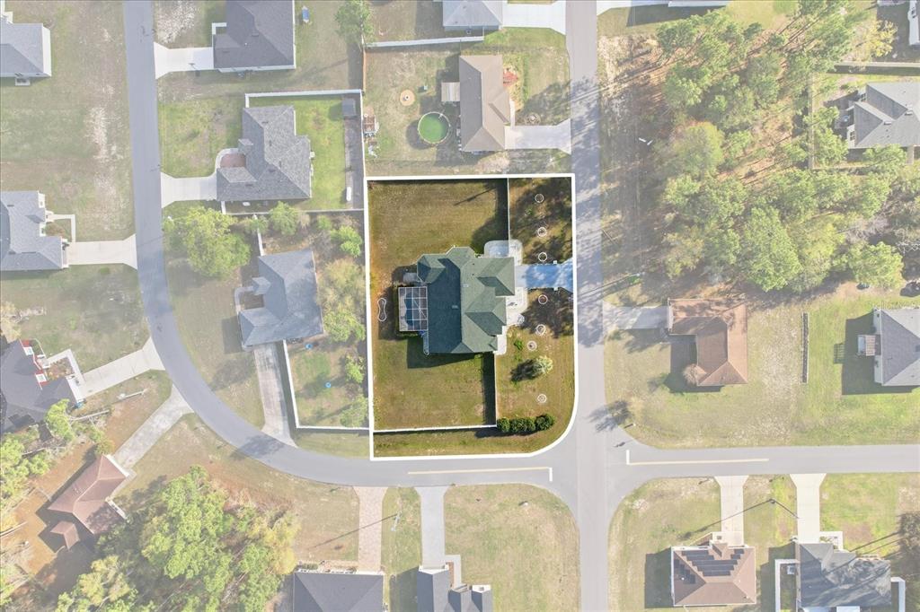A bright green single-story house with a large front porch and a two-car garage — 13061 SW 77TH AVENUE, OCALA, FL