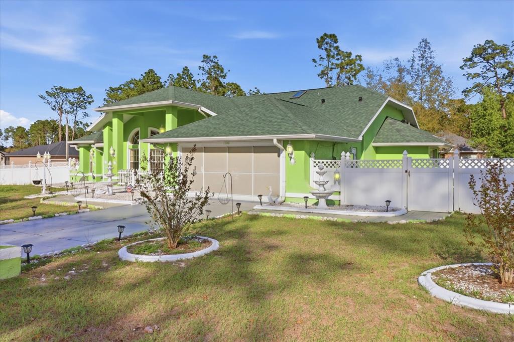 The exterior entrance features a bright green stucco wall, double white doors, and arched windows — 13061 SW 77TH AVENUE, OCALA, FL