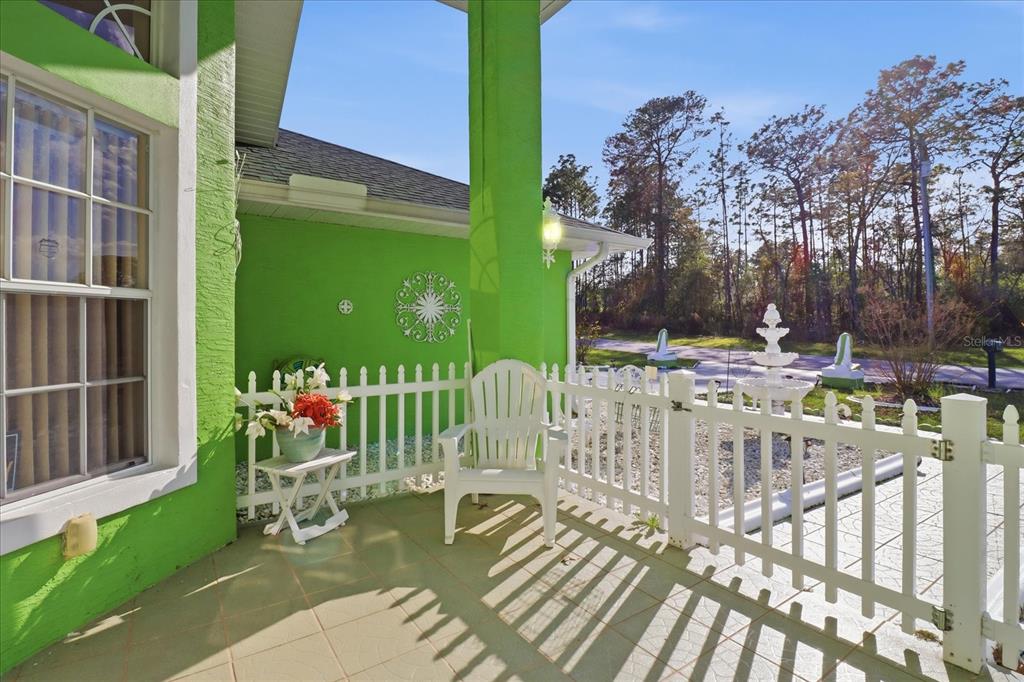 An entryway features a double front door, tiled floor, vaulted ceilings, and arched windows — 13061 SW 77TH AVENUE, OCALA, FL