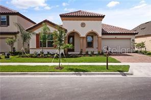 A single-story house with a stucco exterior, arched entryway, and a two-car garage — 9269 OUTLOOK ROCK TRAIL, WINDERMERE, FL