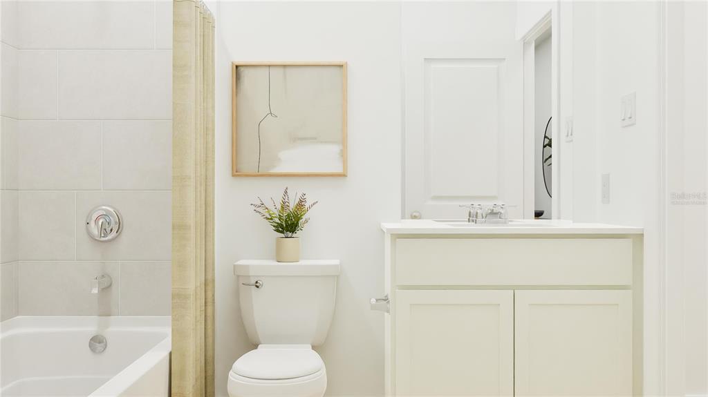 A bathroom features a white vanity, a toilet, and a tiled shower-tub combination — 5382 TEMPEST WAY, CLERMONT, FL