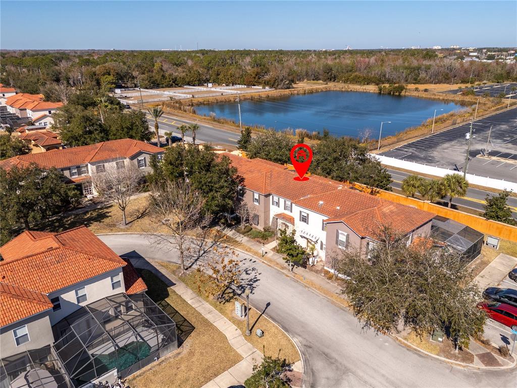 An aerial view shows a multi-unit residential building with a red tile roof — 4554 ALBERTO CIRCLE, KISSIMMEE, FL
