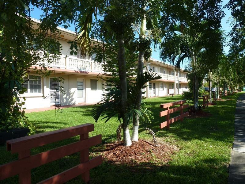 A two-story apartment building with a lawn, palm trees, and a wooden fence — 20337 NE 2nd Avenue, Miami FL 33179, MIAMI, FL