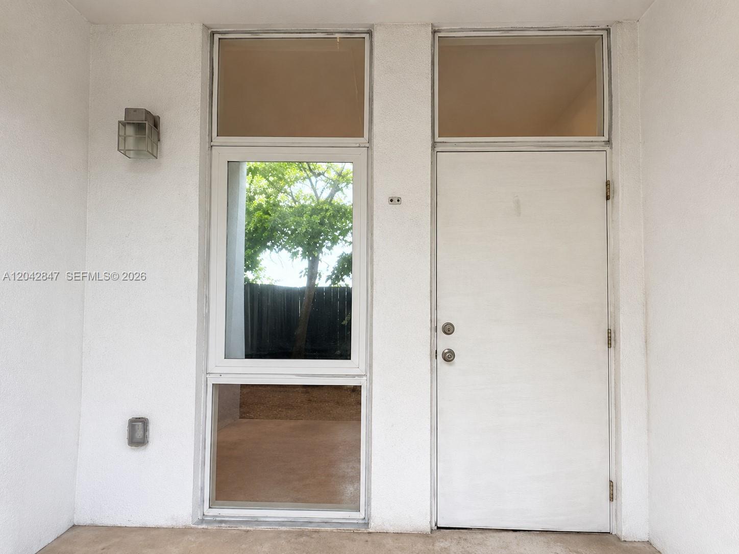 A kitchen with white cabinets, stainless steel appliances, and beige tile flooring — 428 NW 82nd Ter # 426, Miami FL 33150, MIAMI, FL
