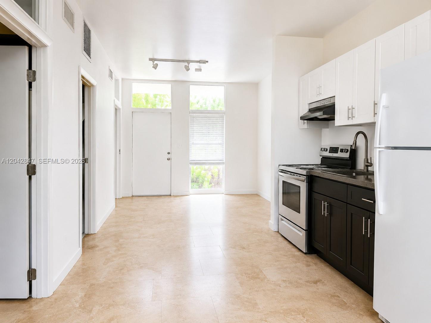 A white exterior door with a side window and transom windows sits on a porch — 428 NW 82nd Ter # 426, Miami FL 33150, MIAMI, FL