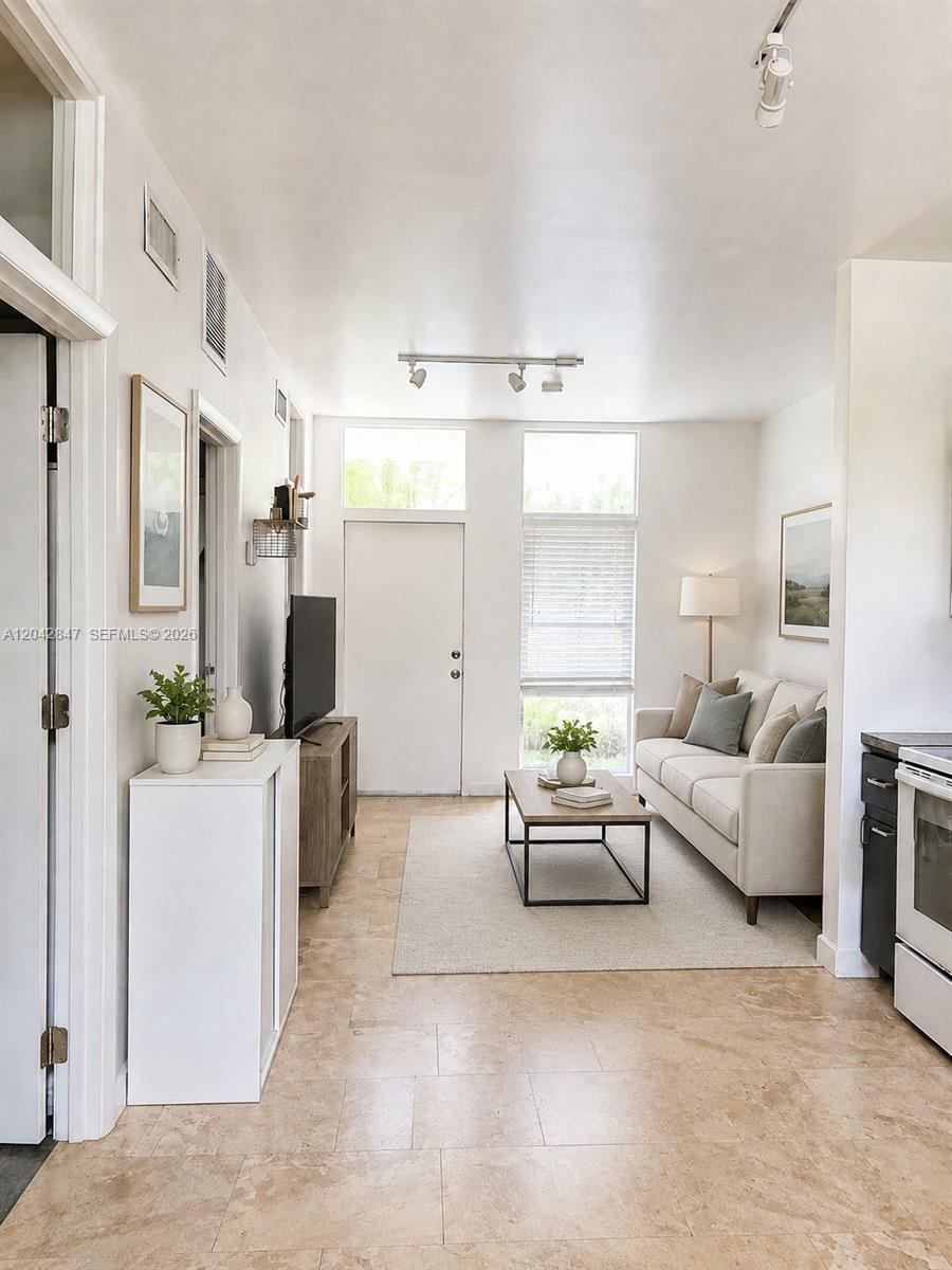 A bathroom features a walk-in glass shower, a white toilet, and a wood-toned vanity — 428 NW 82nd Ter # 426, Miami FL 33150, MIAMI, FL