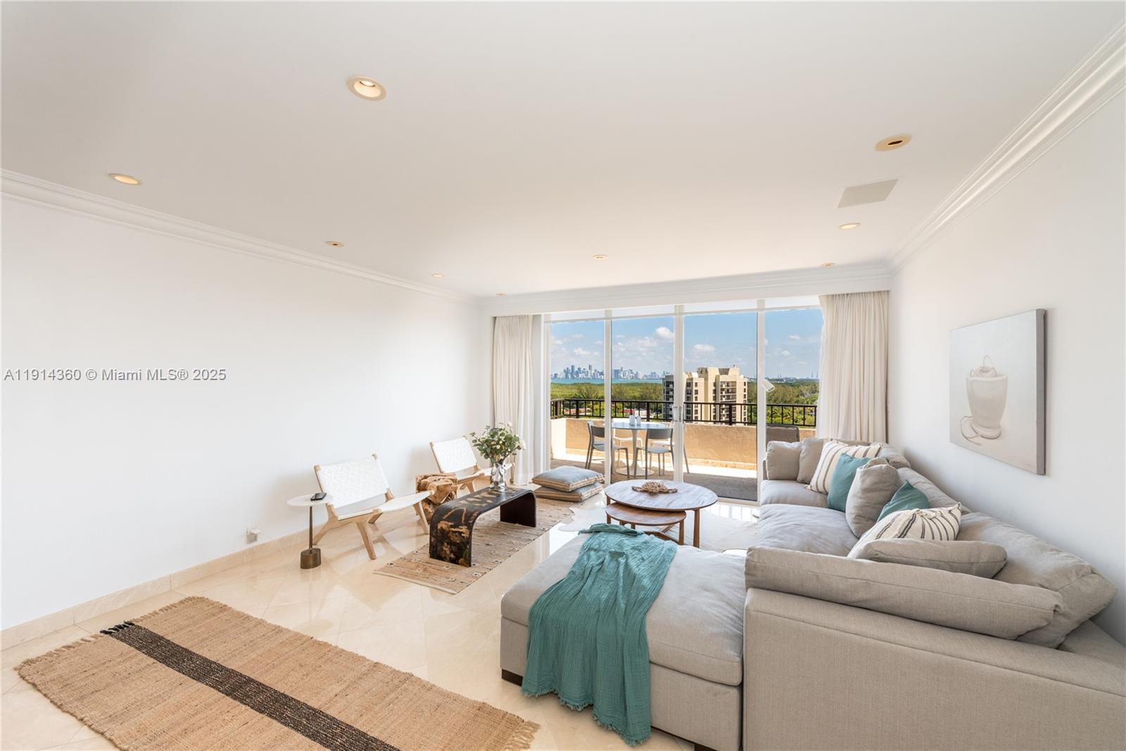 A bright living room features a sectional sofa, two accent chairs, and a balcony view — 151 Crandon Blvd # 1036, Key Biscayne FL 33149, KEY BISCAYNE, FL