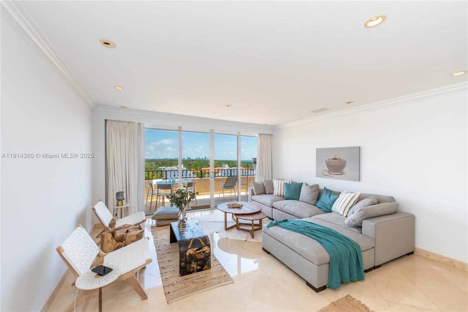 A bright living room features a large gray sectional, two accent chairs, and balcony access — 151 Crandon Blvd # 1036, Key Biscayne FL 33149, KEY BISCAYNE, FL