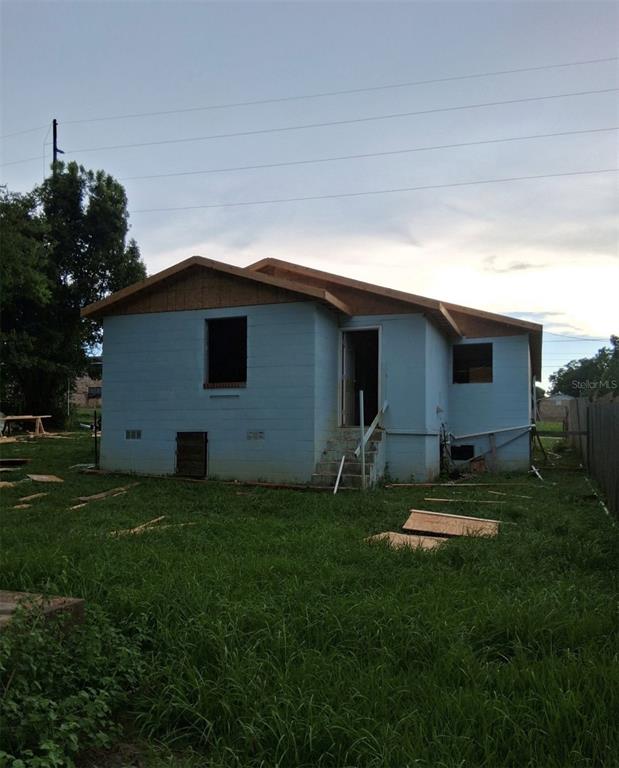 The exterior of a light blue concrete block house under construction with an open doorway — 801 S MAIN STREET, HAVANA, FL