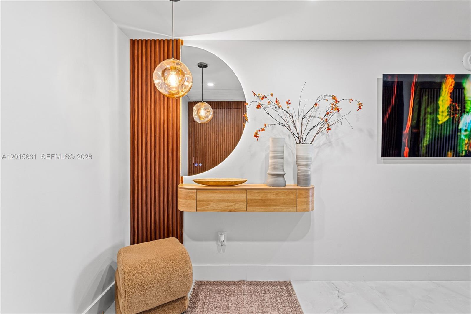 A modern entryway features a floating wooden console, a semi-circular mirror, and vertical wood slats — 465 Brickell Ave # 3301, Miami FL 33131, MIAMI, FL