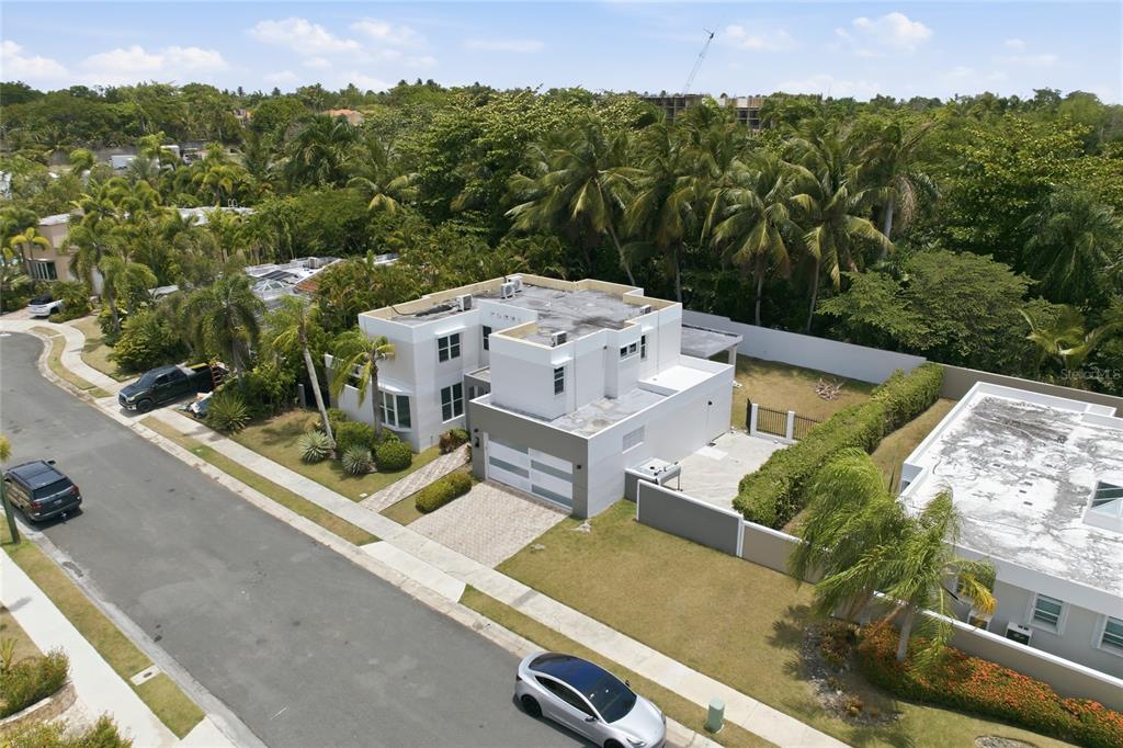 An aerial view shows a modern two-story house with a flat roof and paved driveway — 468 CALLE VIA MEDITERRANEA UNIT 468, DORADO, PR