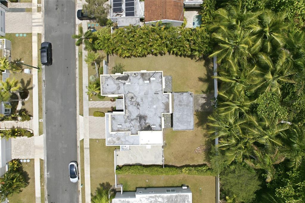 An aerial view shows a house with a flat roof, surrounding lawn, and palm trees — 468 CALLE VIA MEDITERRANEA UNIT 468, DORADO, PR