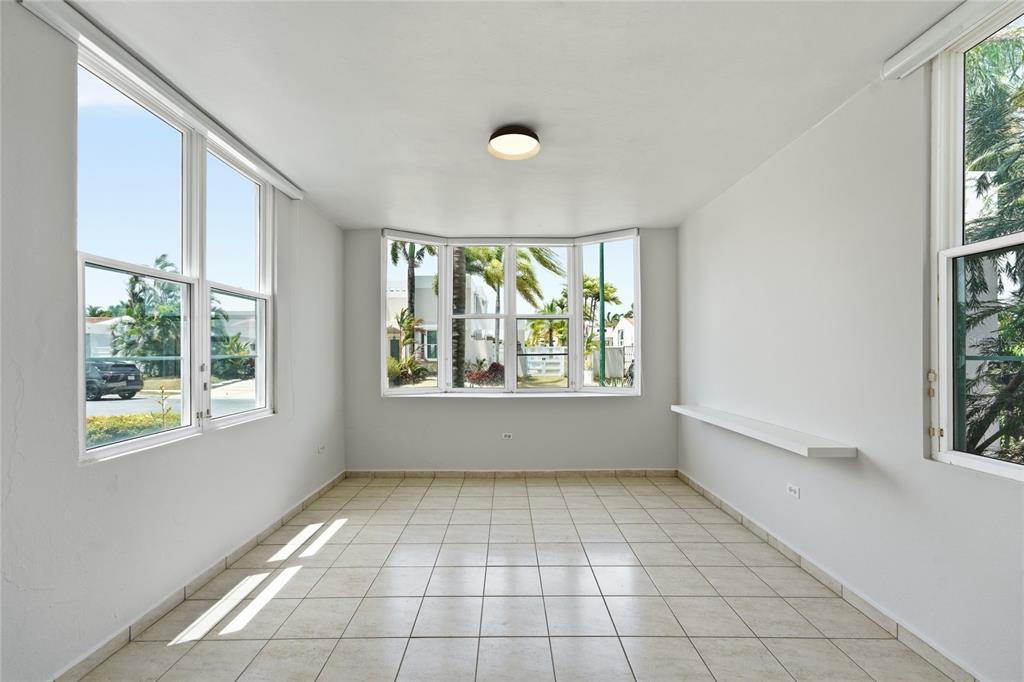 A bright, empty room with light-colored tile floors, white walls, and a large bay window — 468 CALLE VIA MEDITERRANEA UNIT 468, DORADO, PR