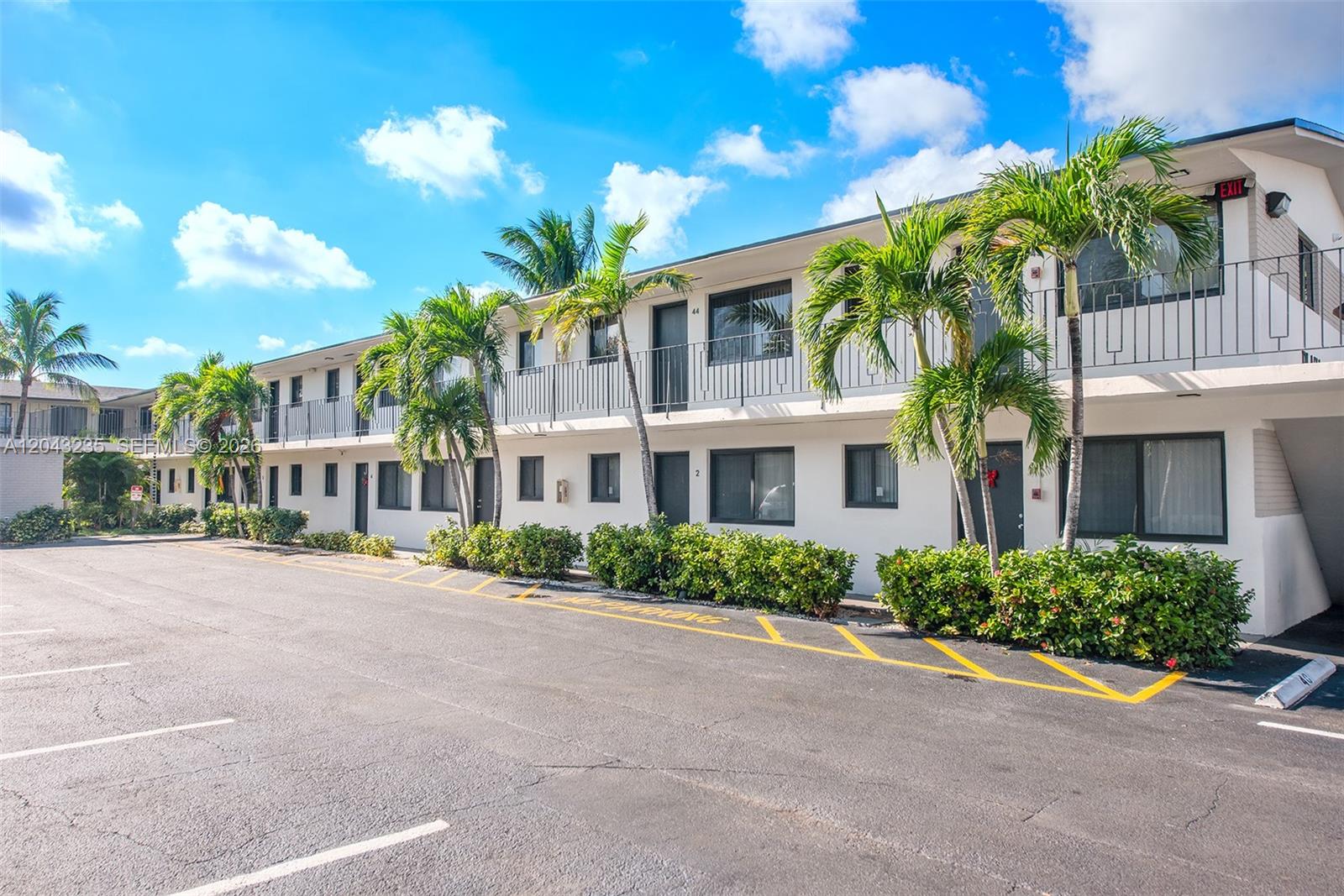 A two-story apartment building with palm trees and a paved parking lot in front — 1310 W 29th St # 40, Hialeah FL 33012, HIALEAH, FL