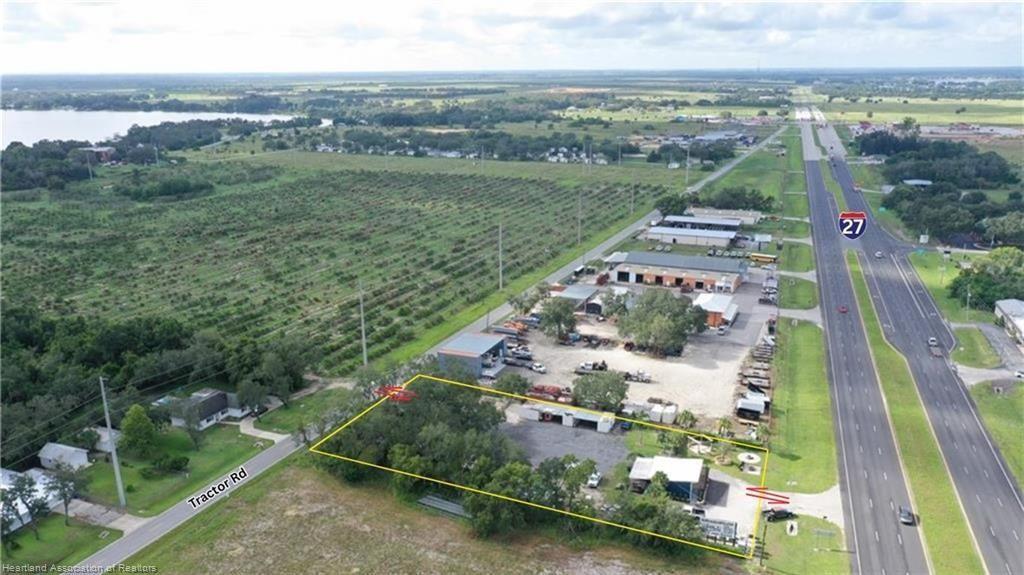 An aerial view shows a commercial property outlined in yellow adjacent to a highway — 6750 US Highway 27, Sebring FL 33870, SEBRING, FL