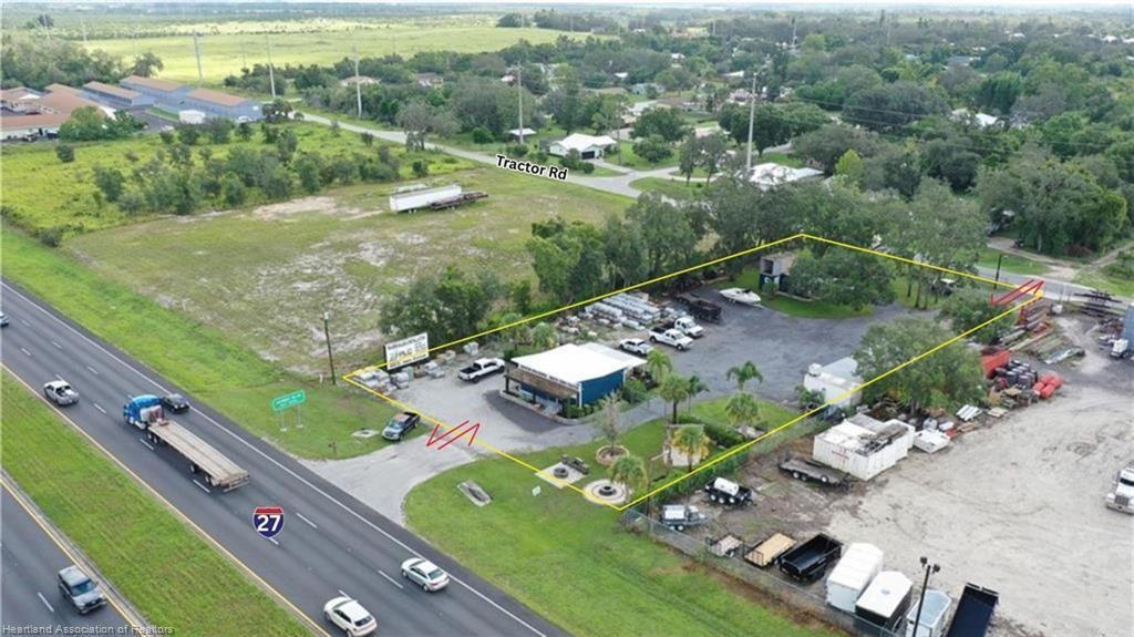 An aerial view shows a commercial property with a building and parking lot bordering a highway — 6750 US Highway 27, Sebring FL 33870, SEBRING, FL