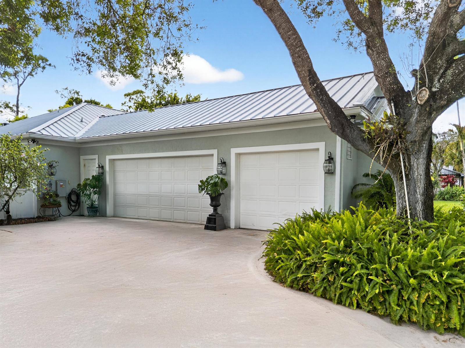 A light green detached garage with two white doors and a metal roof — 14921 Horseshoe Trace, Wellington FL 33414, WELLINGTON, FL