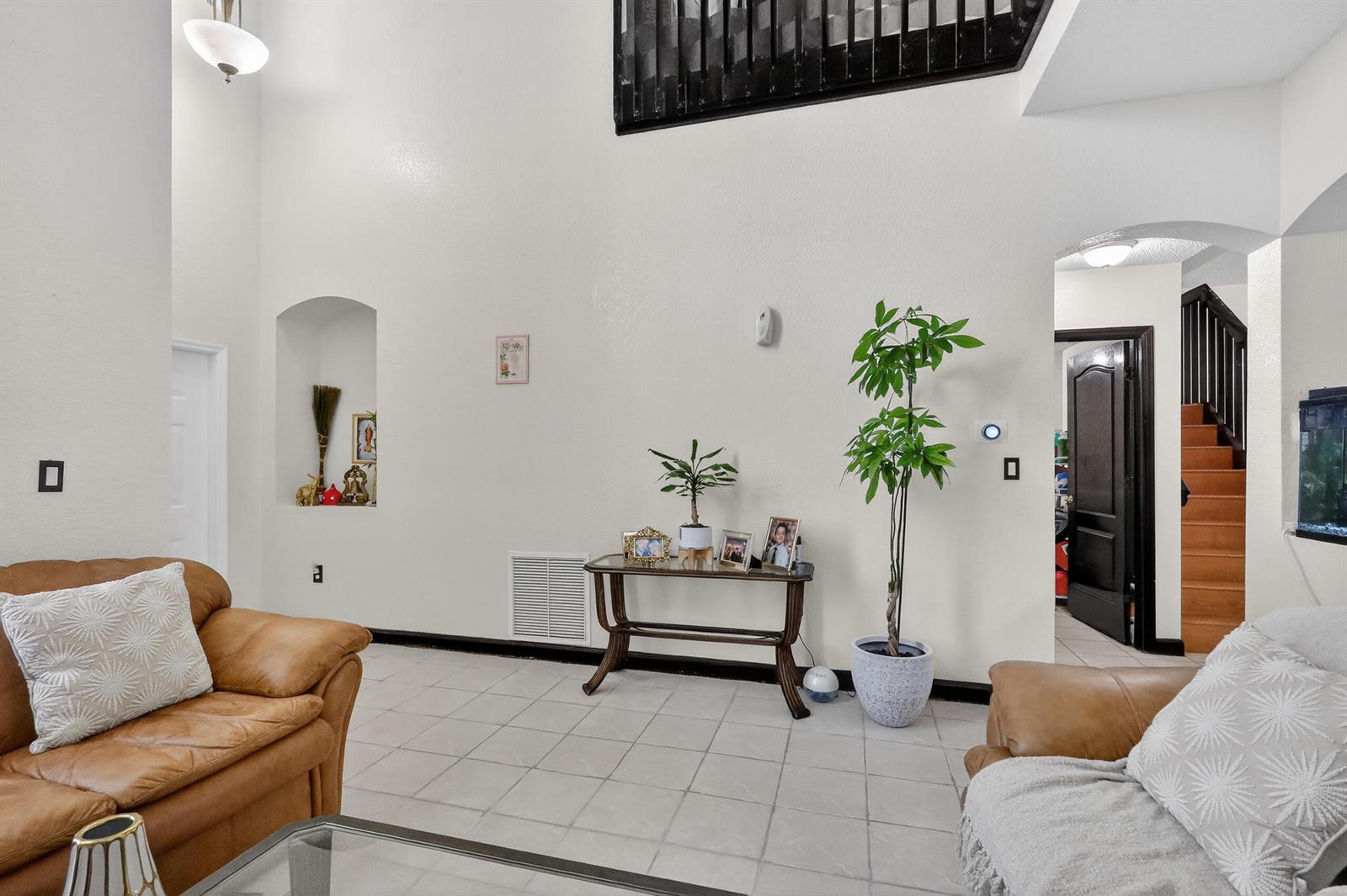 A living room features white walls, tiled floors, a console table, and a staircase visible — 16266 SW 103rd Terrace, Miami FL 33196, MIAMI, FL