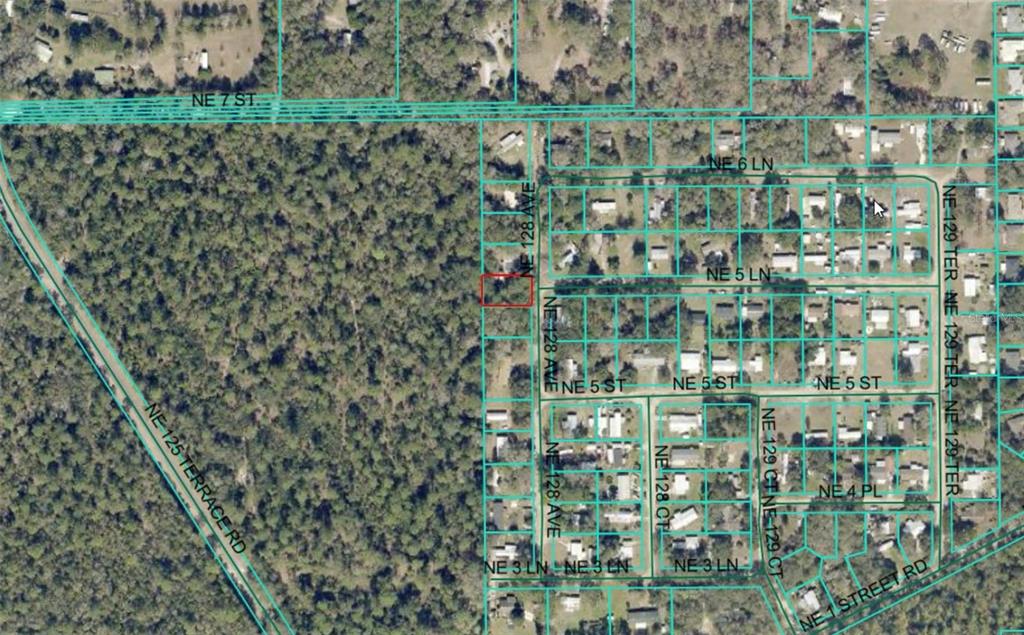 This is an aerial map showing a residential lot highlighted in red — NE 128TH AVENUE, SILVER SPRINGS, FL