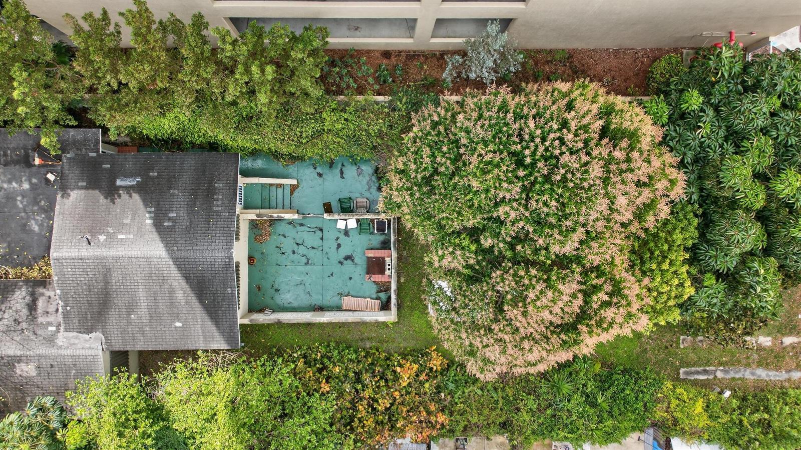 An aerial view shows a house with a green patio, a large tree, and landscaping — 975 SW 37th Avenue, Miami FL 33135, MIAMI, FL