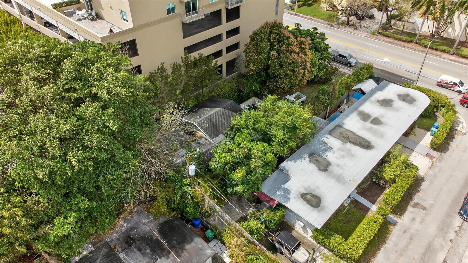 An aerial view shows a residential property with a flat-roofed house and dense surrounding trees — 975 SW 37th Avenue, Miami FL 33135, MIAMI, FL