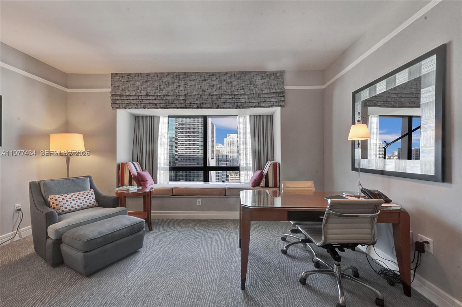A home office features a desk, a lounge chair, and a window seat with city views — 1435 Brickell Ave # 3308, Miami FL 33131, MIAMI, FL