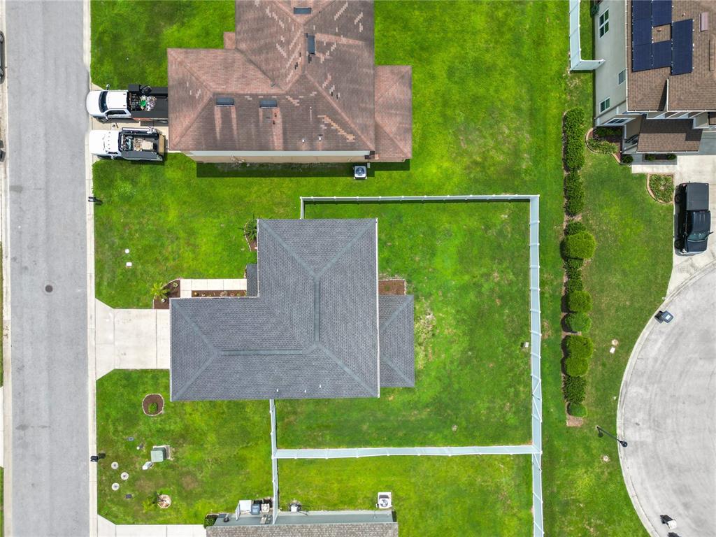 An aerial view shows a residential house with a fenced backyard and surrounding neighborhood streets — 4188 FESTIVAL POINTE BOULEVARD, MULBERRY, FL