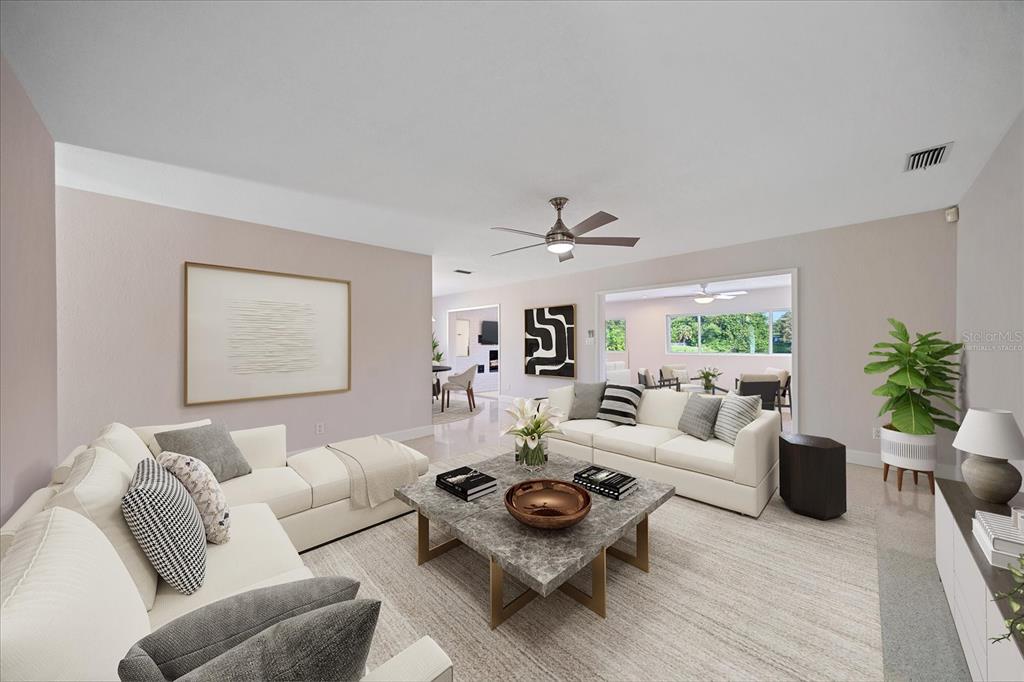 A living room features white sofas, a marble coffee table, and a ceiling fan — 1163 60TH AVENUE S, ST PETERSBURG, FL