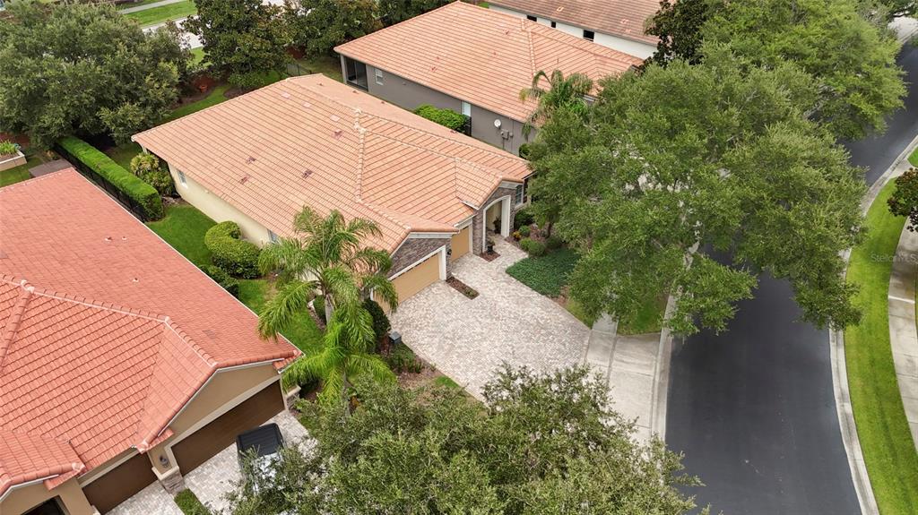 An aerial view shows a suburban house with a tiled roof and a paved driveway — 544 DOUGLAS EDWARD DRIVE, OCOEE, FL