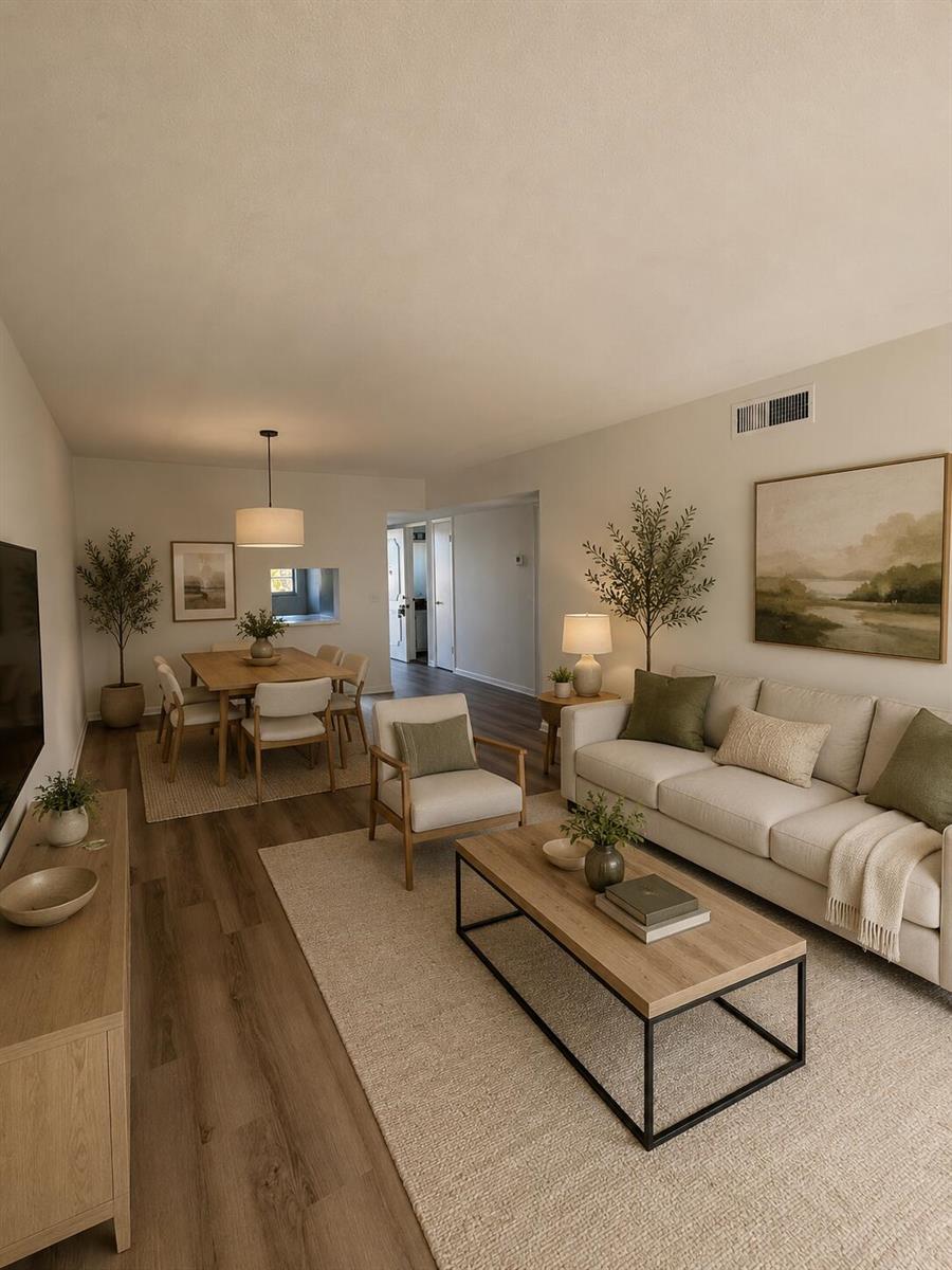 A living and dining room featuring light wood furniture, neutral decor, and wood-look flooring — 130 NE 26th Avenue # 2030, Boynton Beach FL 33435, BOYNTON BEACH, FL