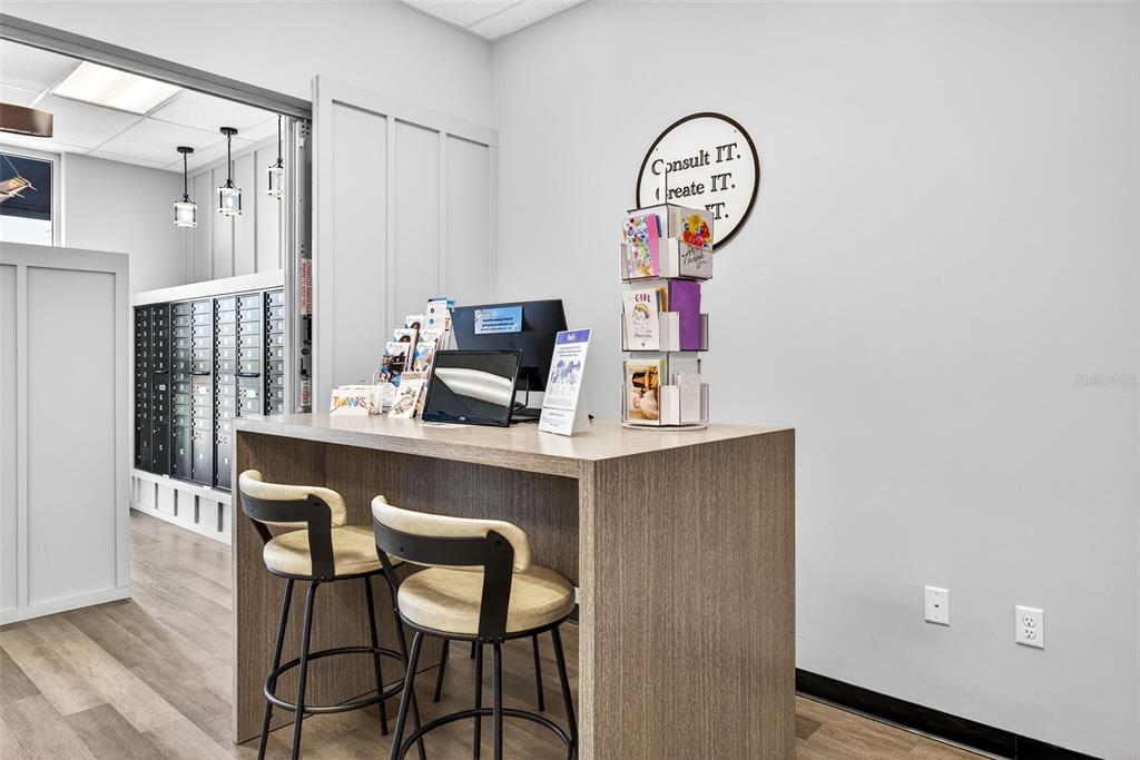 A small office space features a high wooden desk with two stools and a mailroom — 2751 E COUNTY LINE ROAD, LUTZ, FL