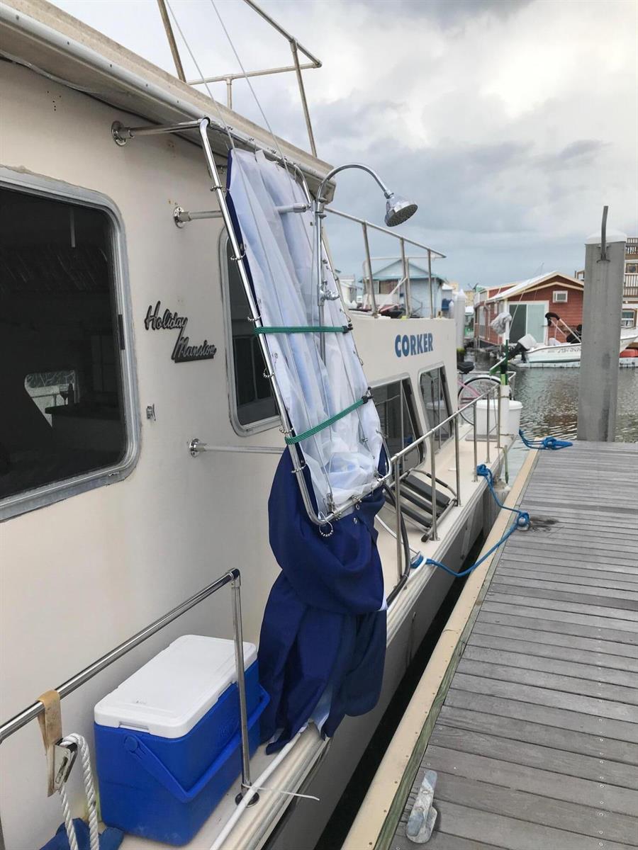 An outdoor shower unit is mounted to the side of a boat docked at a pier — 1801 N Roosevelt Boulevard, Key West FL 33040, KEY WEST, FL