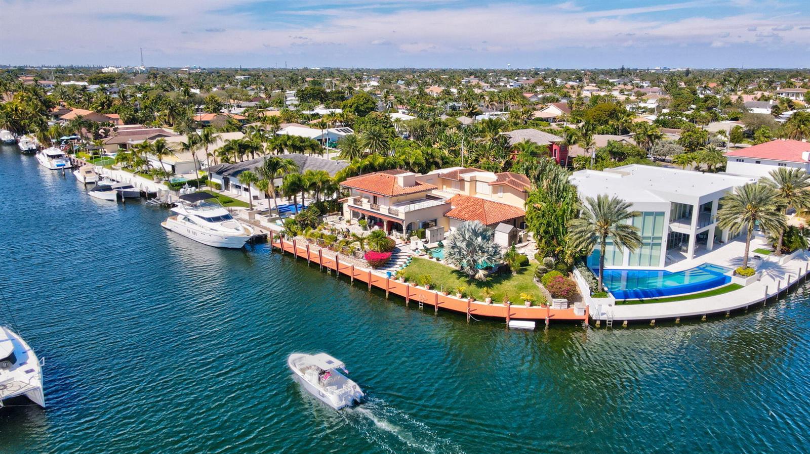 An aerial view shows waterfront homes with private docks, swimming pools, and boats on a canal — 2850 NE 44th Street, Lighthouse Point FL 33064, LIGHTHOUSE POINT, FL