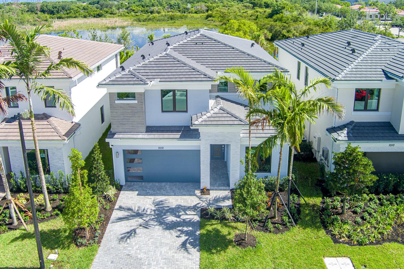 An aerial view of a two-story suburban house with a gray tile roof and driveway — 1012 Raleigh Way, Wellington FL 33414, WELLINGTON, FL