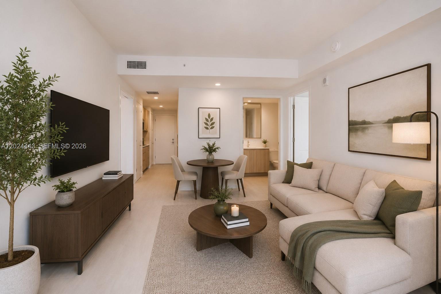 A modern living room features a sectional sofa, dining area, and wall-mounted television — 77 SE 5th st # 2305, Miami FL 33131, MIAMI, FL