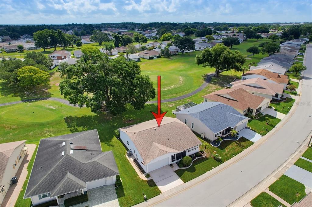 An aerial view shows a single-story house with a shingled roof bordering a golf course — 3537 HIGHLAND FAIRWAYS BOULEVARD, LAKELAND, FL