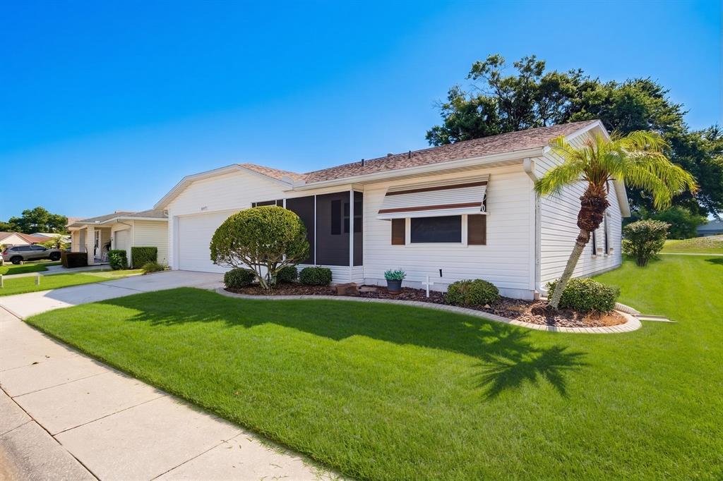 A white single-story house with a screened-in porch, a palm tree, and a green lawn — 3537 HIGHLAND FAIRWAYS BOULEVARD, LAKELAND, FL