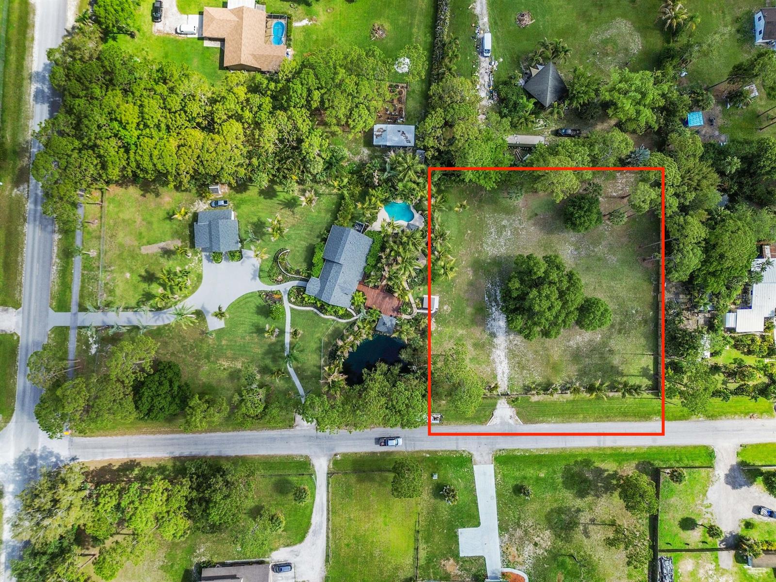 An aerial view shows a vacant, rectangular lot outlined in red next to a house — 13530 42nd Road N, West Palm Beach FL 33411, WEST PALM BEACH, FL